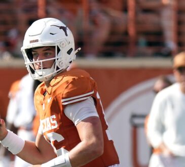 Texas Longhorns quarterback Arch Manning, No. 16, brings the ball back and looks downfield.