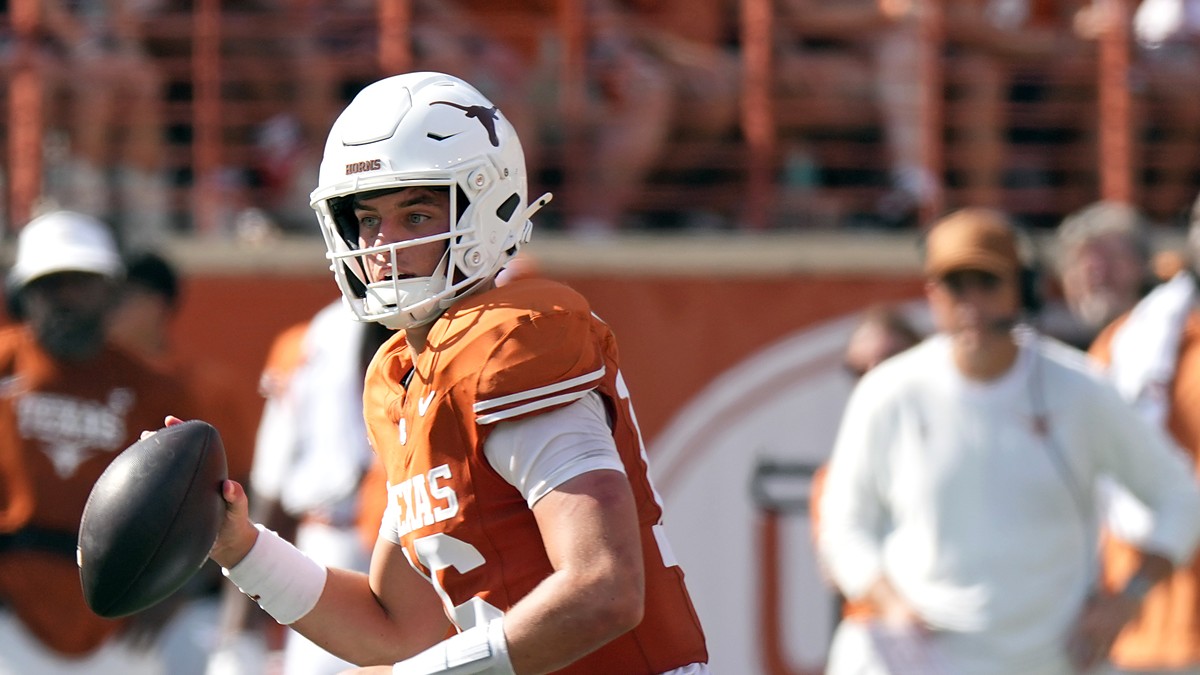 Texas Longhorns quarterback Arch Manning, No. 16, brings the ball back and looks downfield.