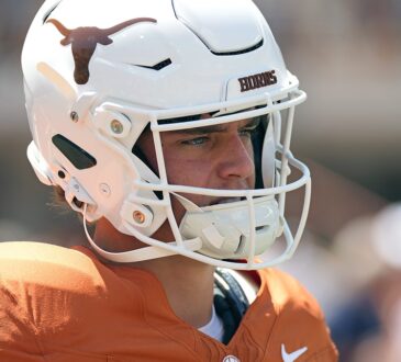 Texas Longhorns quarterback Arch Manning stands in profile in his helmet during pregame warmups.