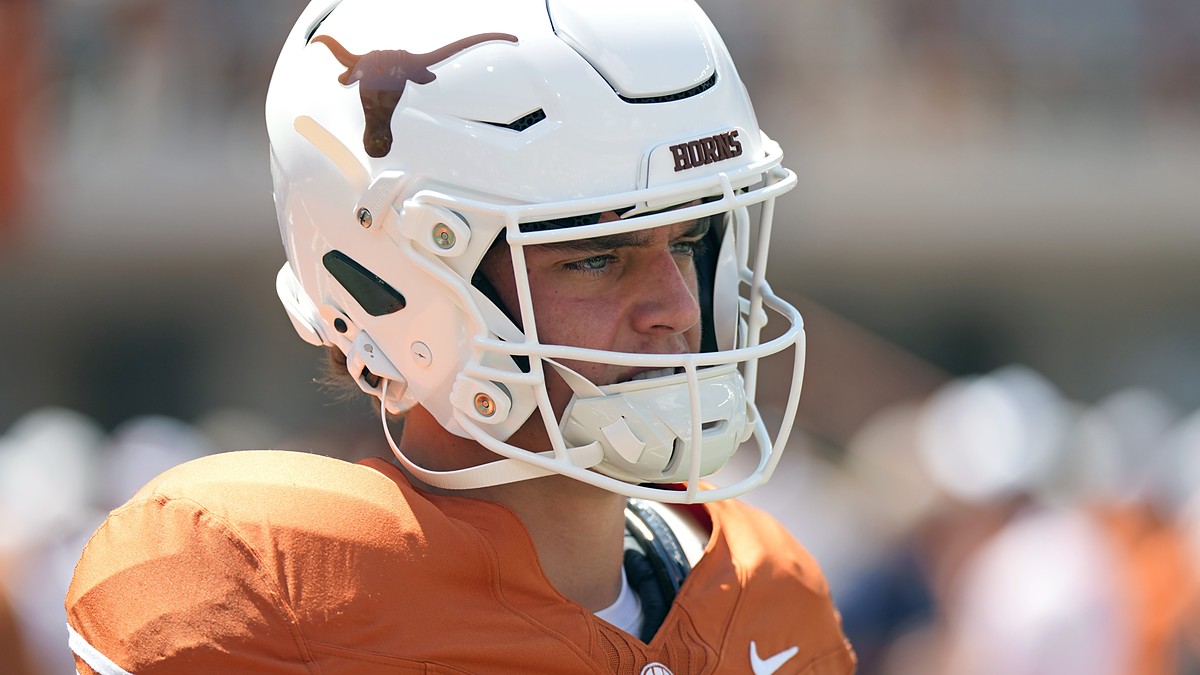 Texas Longhorns quarterback Arch Manning stands in profile in his helmet during pregame warmups.