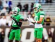 North Texas Mean Green wide receiver Baron Tipton, No. 80, stands on the field beside a teammate during a road game.