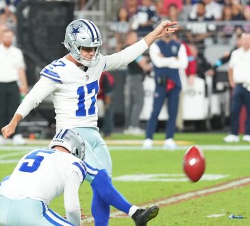 Dallas Cowboys place kicker Brandon Aubrey follows through on a field goal as his holder kneels beside him.