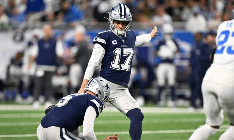 Dallas Cowboys place kicker Brandon Aubrey swings through a field goal attempt as a teammate holds the ball.