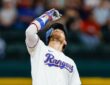 Texas Rangers right fielder Brandon Nimmo points skyward at second base after an RBI double at Globe Life Field.