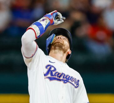 Texas Rangers right fielder Brandon Nimmo points skyward at second base after an RBI double at Globe Life Field.