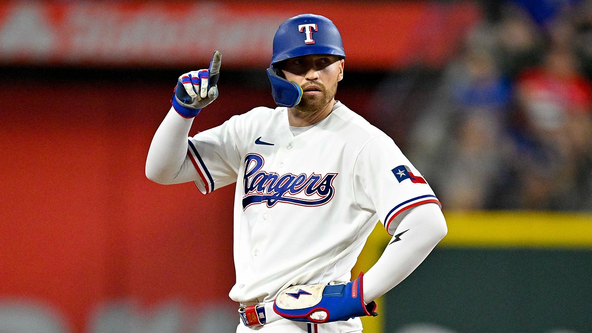 Texas Rangers right fielder Brandon Nimmo stands at second base and points one finger in the air.