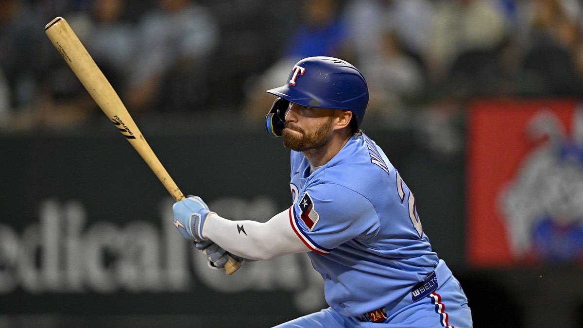 Texas Rangers right fielder Brandon Nimmo watches the ball after a swing in a powder blue Rangers uniform.