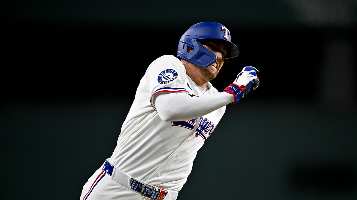 Texas Rangers center fielder Brandon Nimmo runs the bases in his home whites with his arms pumping.