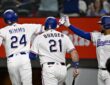 Rangers teammates Brandon Nimmo, Jake Burger, and Elias Díaz celebrate after a run scores.