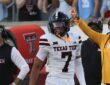 Texas Tech defensive back Brenden Jordan, No. 7, smiles and raises a finger after recovering a fumble.