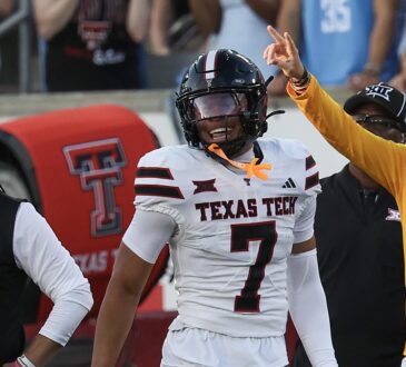 Texas Tech defensive back Brenden Jordan, No. 7, smiles and raises a finger after recovering a fumble.