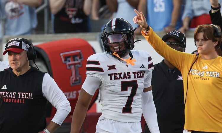 Texas Tech defensive back Brenden Jordan, No. 7, smiles and raises a finger after recovering a fumble.