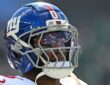 New York Giants linebacker Brian Burns looks toward the field in his helmet during a game against Philadelphia.