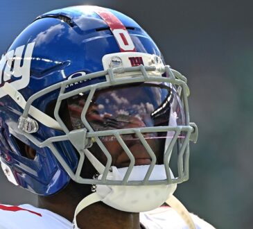 New York Giants linebacker Brian Burns looks toward the field in his helmet during a game against Philadelphia.