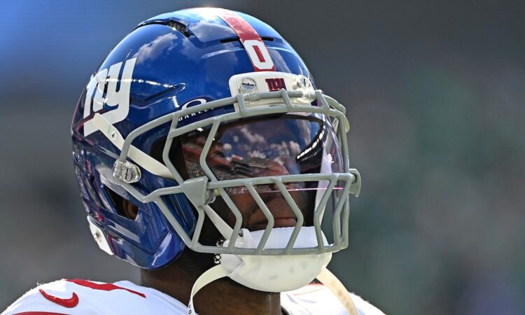 New York Giants linebacker Brian Burns looks toward the field in his helmet during a game against Philadelphia.
