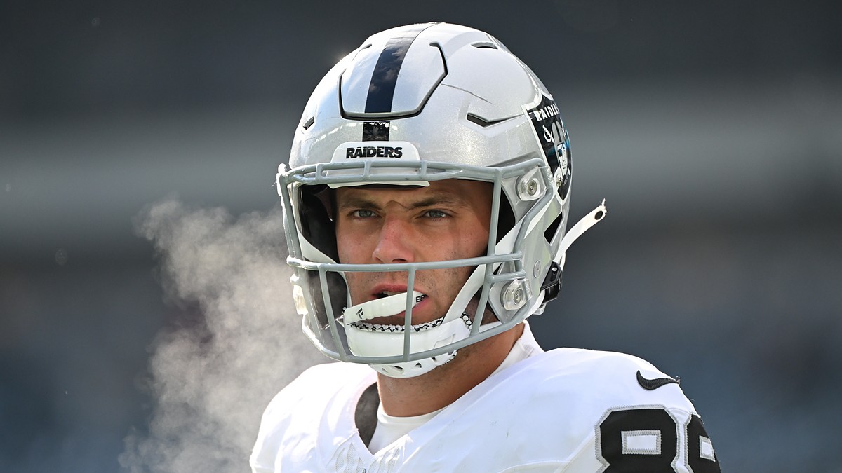 Las Vegas Raiders tight end Brock Bowers looks on in his helmet before a cold-weather game against the Eagles.