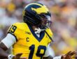 Michigan Wolverines quarterback Bryce Underwood spreads his arms in celebration after scoring against Western Michigan.