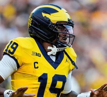 Michigan Wolverines quarterback Bryce Underwood spreads his arms in celebration after scoring against Western Michigan.