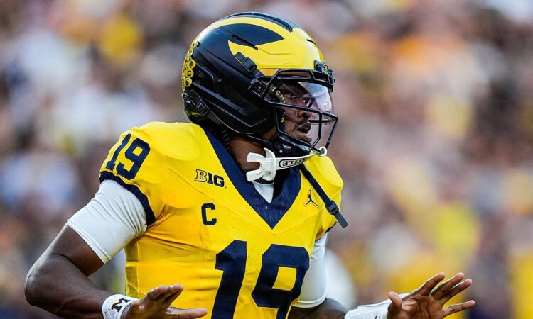 Michigan Wolverines quarterback Bryce Underwood spreads his arms in celebration after scoring against Western Michigan.