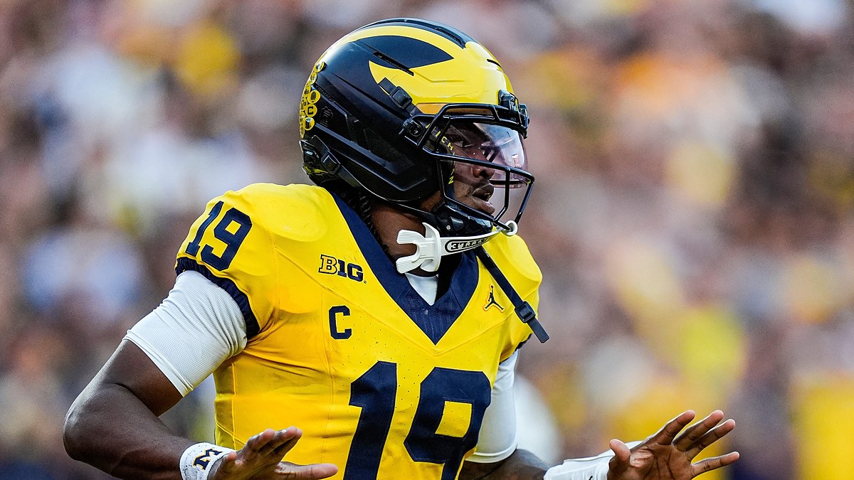 Michigan Wolverines quarterback Bryce Underwood spreads his arms in celebration after scoring against Western Michigan.