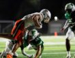 Mandarin wide receiver Brysen Wright is upended near the sideline as Nease defender Austin Taylor wraps him up.