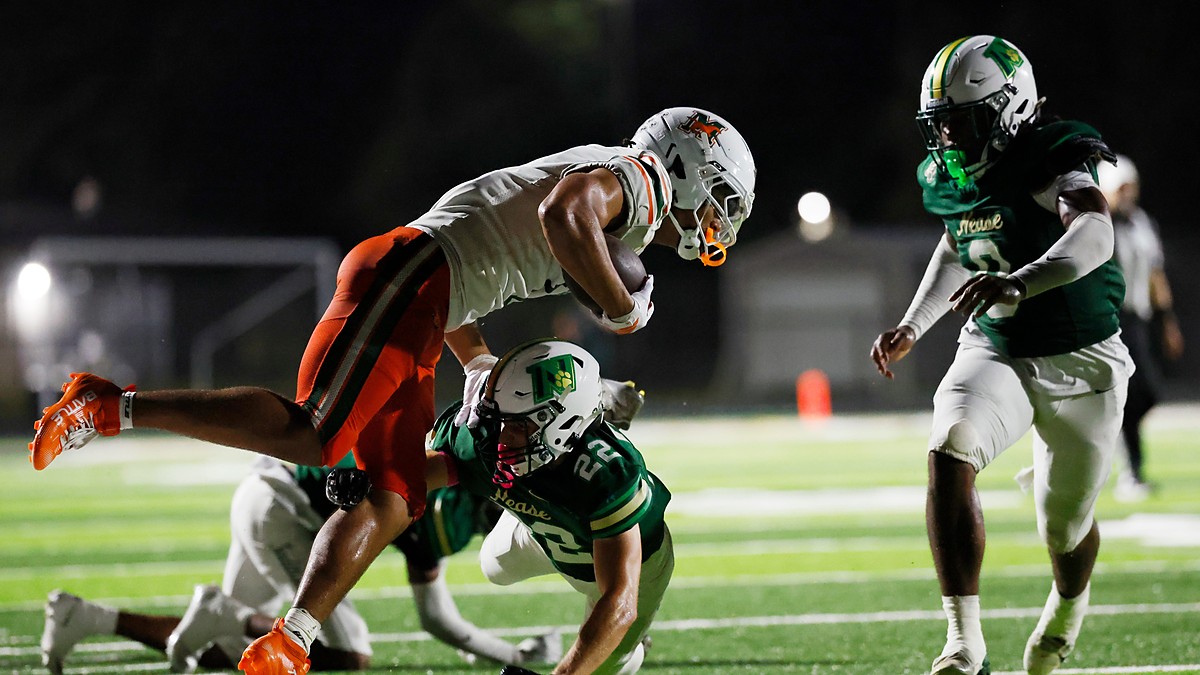 Mandarin wide receiver Brysen Wright is upended near the sideline as Nease defender Austin Taylor wraps him up.