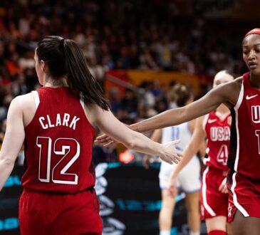 United States guard Caitlin Clark slaps hands with teammate Angel Reese during a game at the FIBA Women's World Cup.