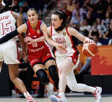 United States guard Caitlin Clark drives past a Czechia defender as teammate Angel Reese sets a screen.