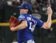 Texas Rangers pitcher Cal Quantrill winds up with the ball in his raised hand during a game at Chase Field.