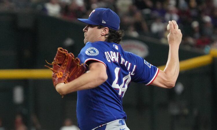 Texas Rangers pitcher Cal Quantrill winds up with the ball in his raised hand during a game at Chase Field.