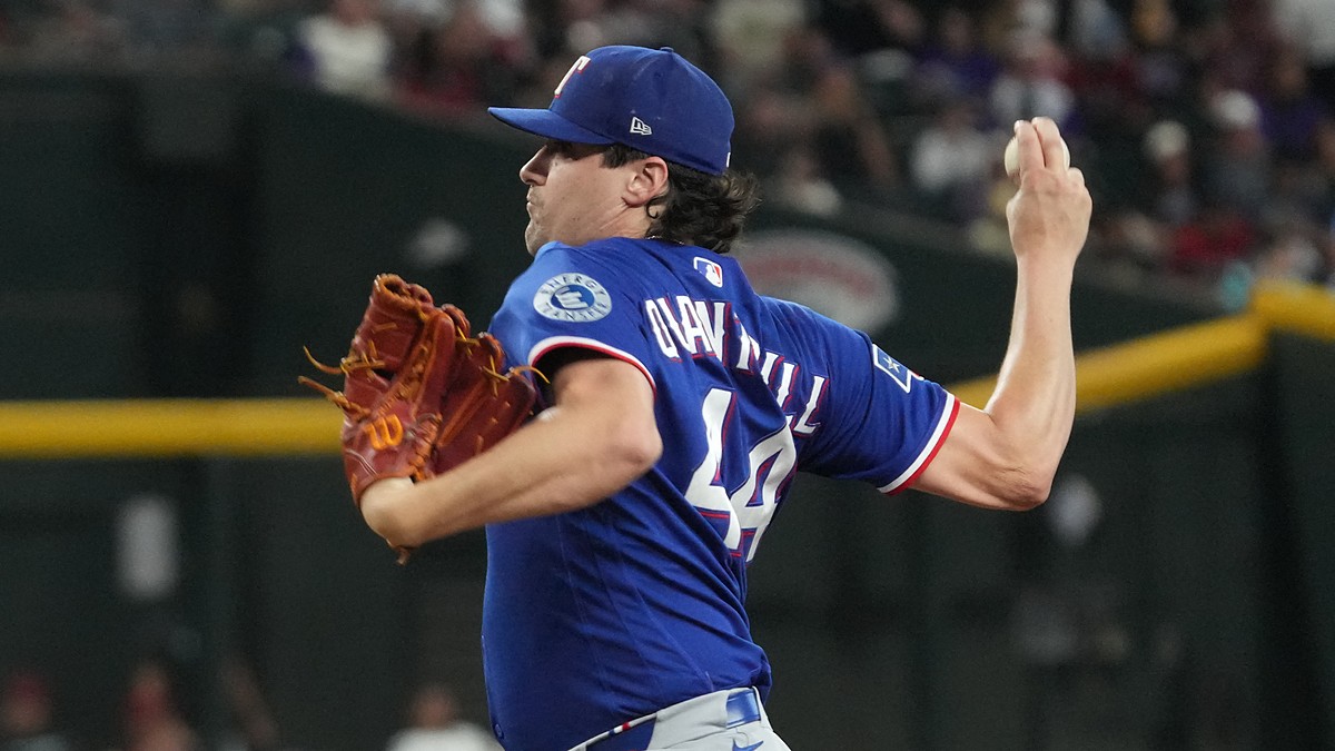 Texas Rangers pitcher Cal Quantrill winds up with the ball in his raised hand during a game at Chase Field.