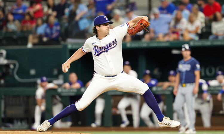 Texas Rangers right-hander Cal Quantrill, No. 44, strides toward the plate mid-delivery at Globe Life Field.