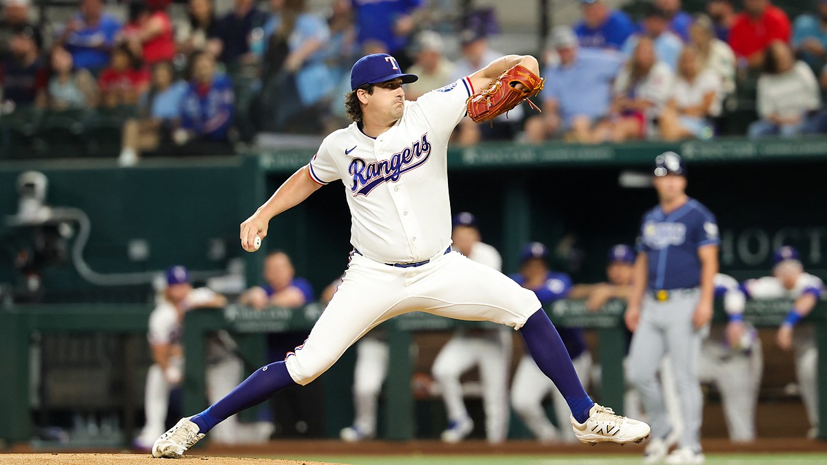 Texas Rangers right-hander Cal Quantrill, No. 44, strides toward the plate mid-delivery at Globe Life Field.