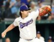 Texas Rangers pitcher Cal Quantrill rears back to throw in his white home uniform at Globe Life Field.