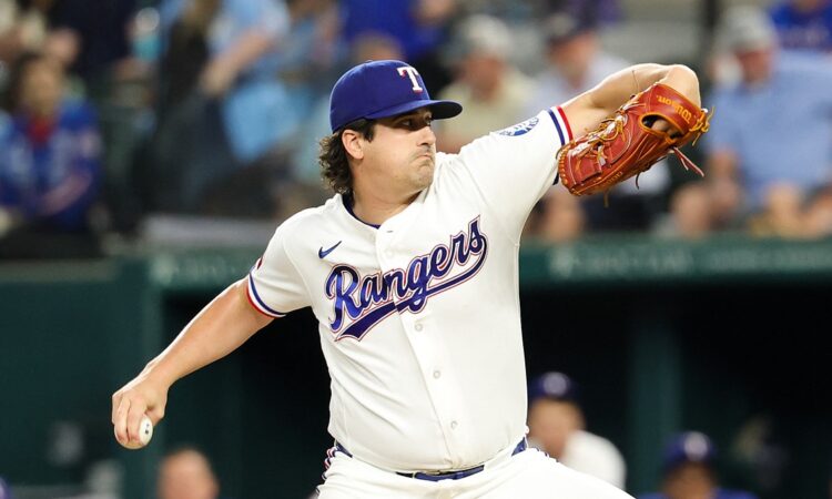 Texas Rangers pitcher Cal Quantrill rears back to throw in his white home uniform at Globe Life Field.