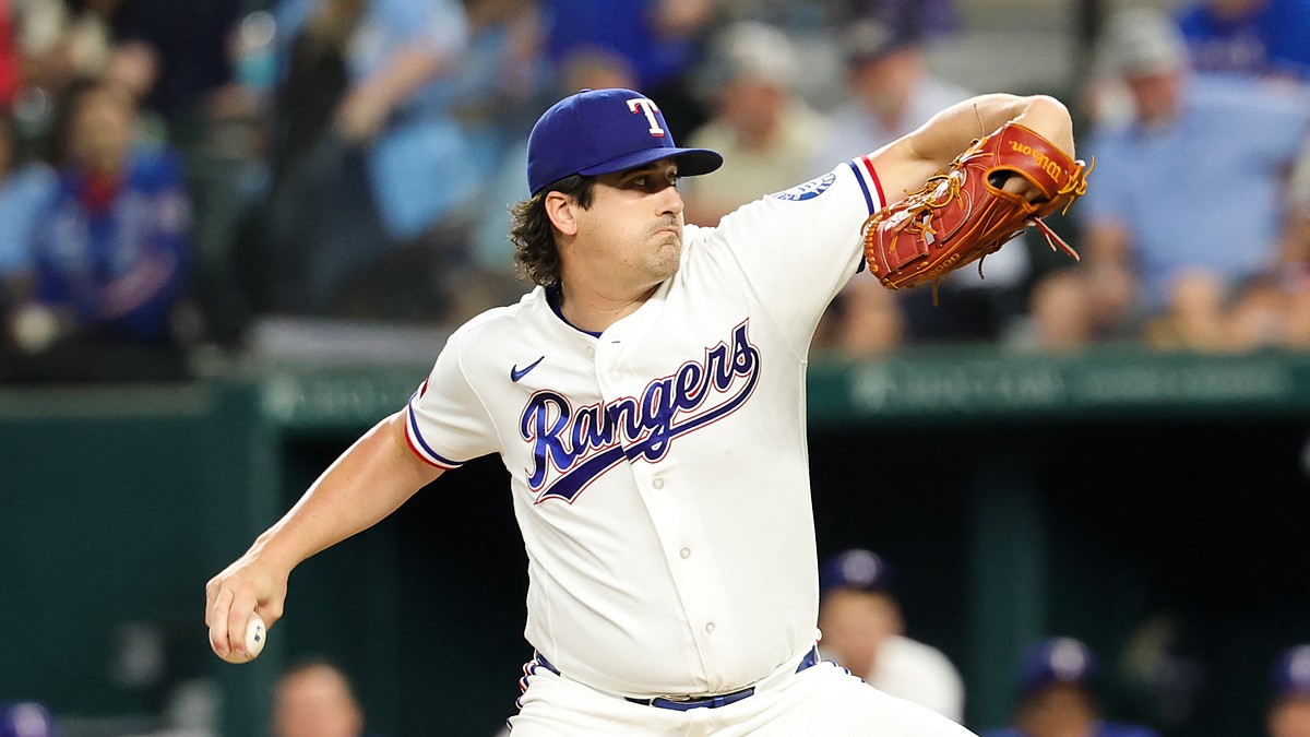 Texas Rangers pitcher Cal Quantrill rears back to throw in his white home uniform at Globe Life Field.