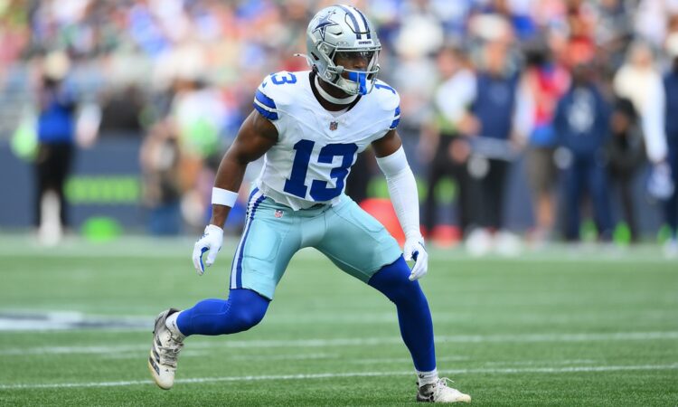 Dallas Cowboys safety Caleb Downs settles into a wide defensive stance on the field.
