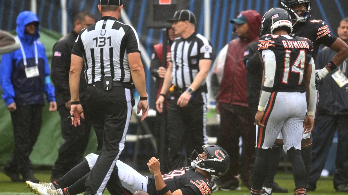 Chicago Bears quarterback Caleb Williams #18 lies on the field with an apparent injury against the Minnesota Vikings at Soldier Field.