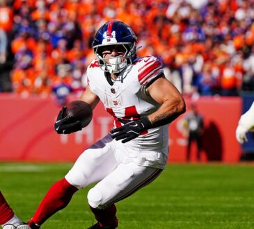 New York Giants running back Cam Skattebo, No. 44, plants and cuts with the ball in his left hand.