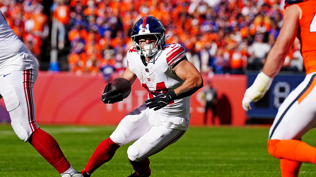 New York Giants running back Cam Skattebo, No. 44, plants and cuts with the ball in his left hand.