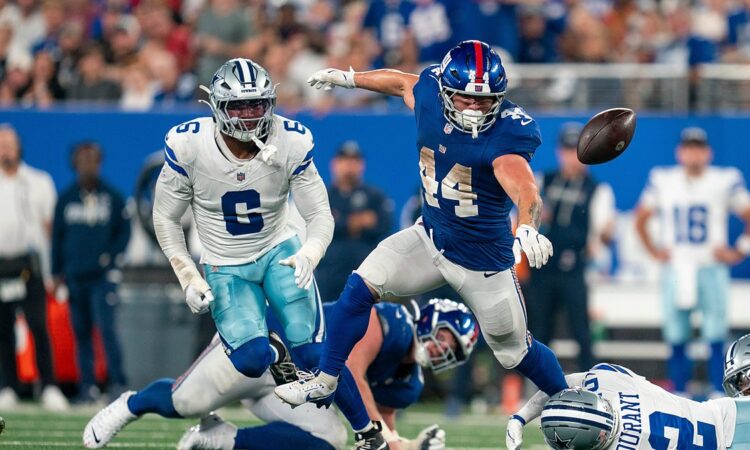 New York Giants running back Cam Skattebo loses the football as Dallas Cowboys defenders converge.