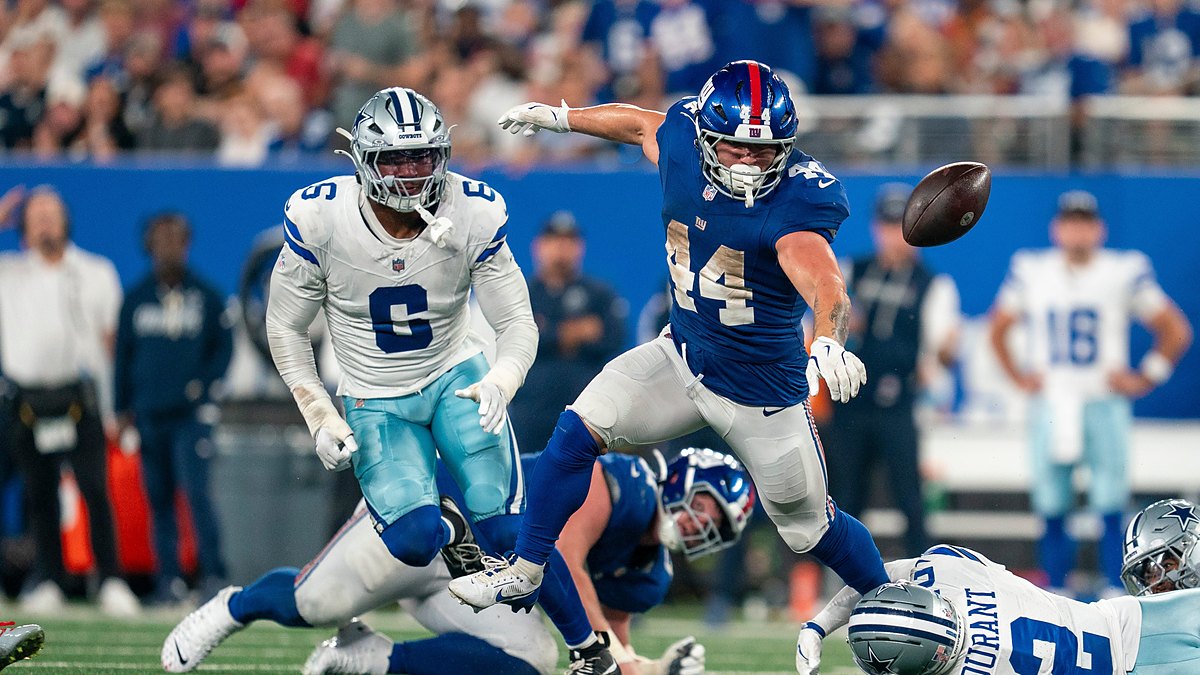 New York Giants running back Cam Skattebo loses the football as Dallas Cowboys defenders converge.
