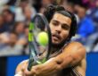 Spain's Carlos Alcaraz strikes a two-handed backhand during a night match at the U.S. Open.