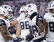 Dallas Cowboys wide receiver CeeDee Lamb shakes hands with teammates as they celebrate his touchdown catch in the end zone.