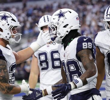 Dallas Cowboys wide receiver CeeDee Lamb shakes hands with teammates as they celebrate his touchdown catch in the end zone.