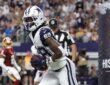 Cowboys wide receiver CeeDee Lamb clutches the football in the end zone after a touchdown catch.