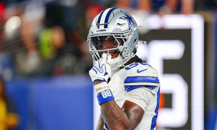 Dallas Cowboys wide receiver CeeDee Lamb raises a finger to his facemask as he reacts during a game against the Giants.
