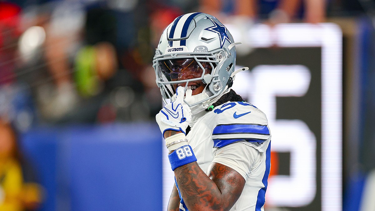 Dallas Cowboys wide receiver CeeDee Lamb raises a finger to his facemask as he reacts during a game against the Giants.
