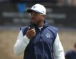 Dallas Cowboys defensive coordinator Christian Parker speaks into a radio during training camp practice.
