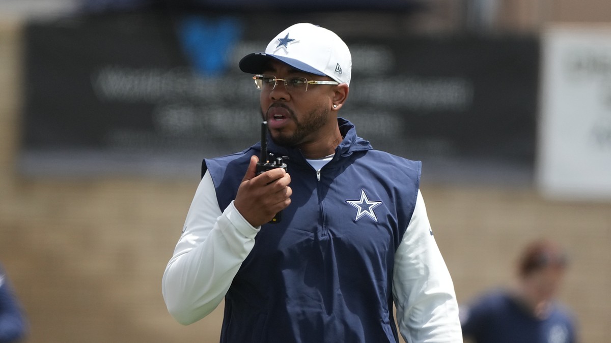 Dallas Cowboys defensive coordinator Christian Parker speaks into a radio during training camp practice.